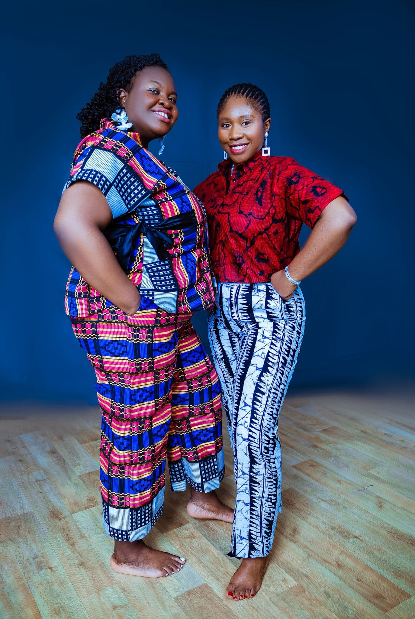 Woman in teal patterned Ankara set against a blue backdrop